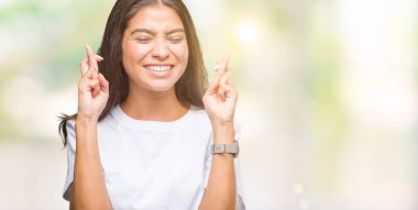 Genç güzel Arap kadın geçiş parmakları umut ve gözleri kapalı ile gülümseyen izole arka plan yüzünden. Şans ve batıl kavramı.