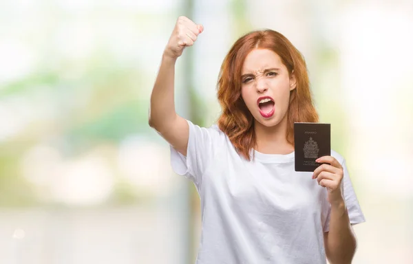 Jovem Bela Mulher Segurando Passaporte Canadá Sobre Fundo Isolado Irritado — Fotografia de Stock