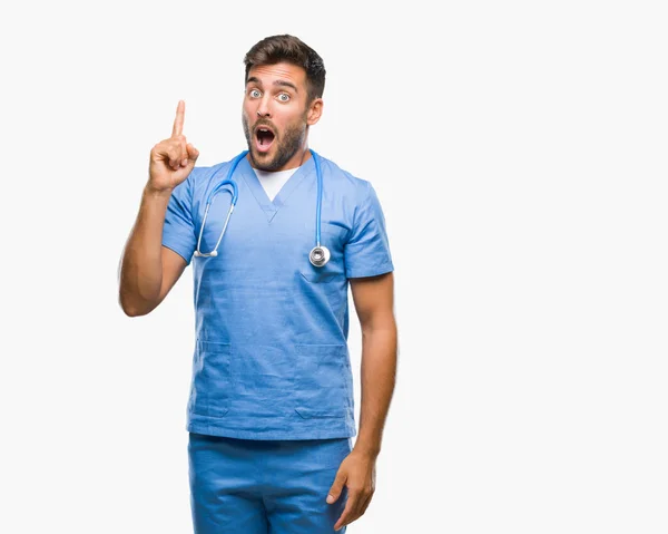 Mladý Pohledný Doktor Chirurg Muž Nad Izolované Pozadí Ukazující Prst — Stock fotografie