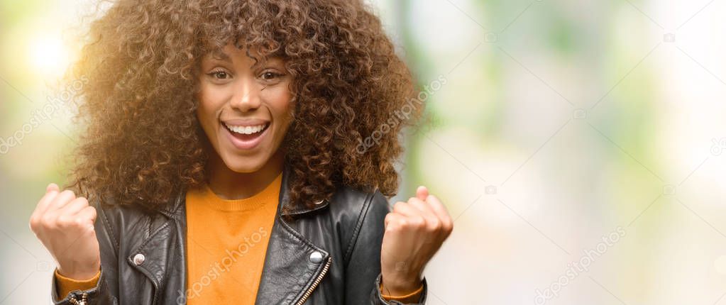 African american woman wearing a leather jacket screaming proud and celebrating victory and success very excited, cheering emotion