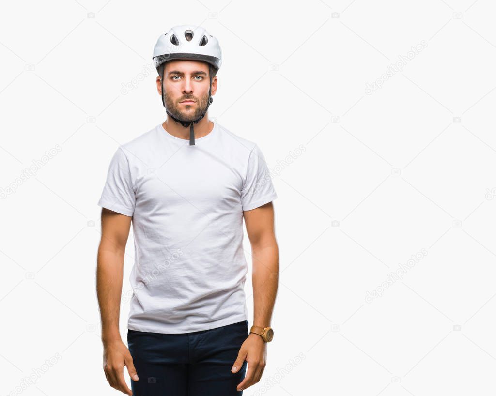 Young handsome man wearing cyclist safety helmet over isolated background with serious expression on face. Simple and natural looking at the camera.
