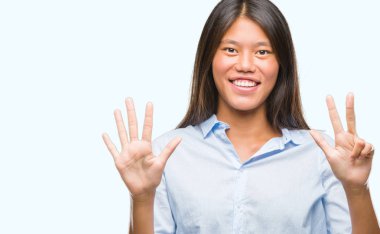 Genç Asyalı iş kadını gösterilen ve parmakları ile işaret izole arka plan üzerinde kendinden emin ve mutlu gülümseyerek süre sekiz numara.