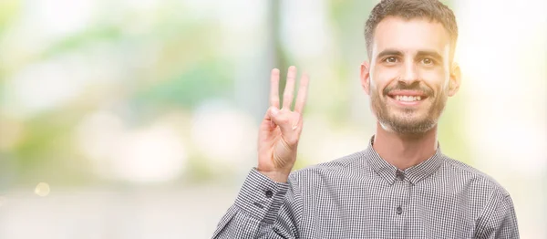 Young Hipster Man Showing Pointing Fingers Number Three While Smiling — Stock Photo, Image