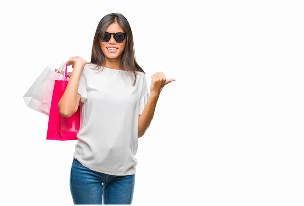 Young Asian Woman Holding Shopping Bags Sales Isolated Background Pointing — Stock Photo, Image