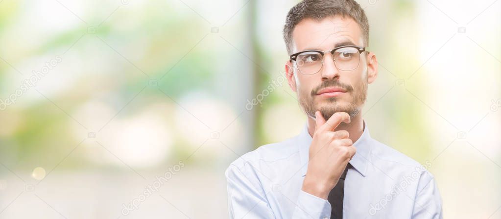 Young business man serious face thinking about question, very confused idea
