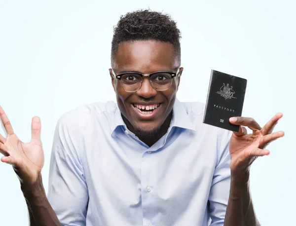 Joven Afroamericano Portador Pasaporte Australiano Muy Feliz Emocionado Expresión Ganadora —  Fotos de Stock