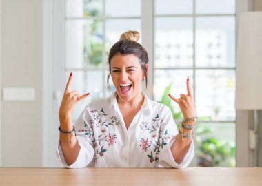 Genç kadın deli ifade rock simge elle yapıyor ile ev bağırarak. Müzik yıldızı. Ağır kavramı.