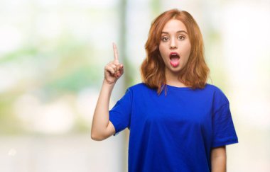 Genç güzel kadın başarılı fikirle parmağı yukarıyı izole arka plan yüzünden. Çıktıktan ve mutlu. Bir numara.