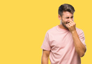 Yakışıklı delikanlı bir şey pis ve iğrenç kokulu izole arka plan, dayanılmaz koku, holding nefes burun parmaklar ile. Kötü kokuyor kavramı.