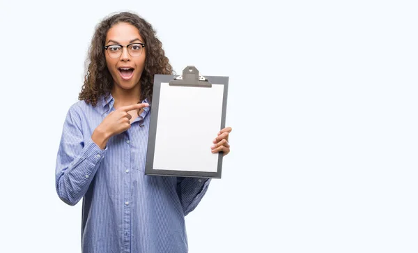 Joven Mujer Negocios Hispana Sosteniendo Portapapeles Muy Feliz Señalando Con —  Fotos de Stock