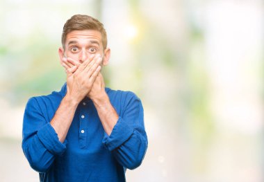 Yakışıklı delikanlı izole arka plan ağız hata için elleriyle kapsayan şok içinde. Gizli kavramı.