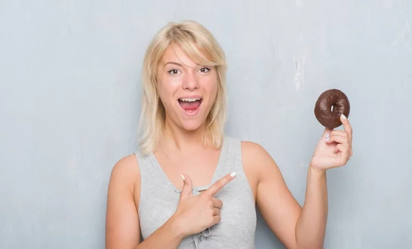 Mulher Adulta Branca Sobre Parede Grunge Cinza Comendo Donut Chocolate — Fotografia de Stock