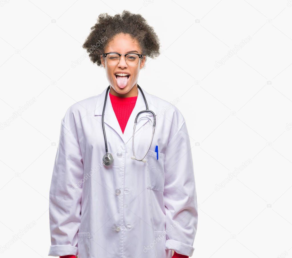 Young afro american doctor woman over isolated background sticking tongue out happy with funny expression. Emotion concept.