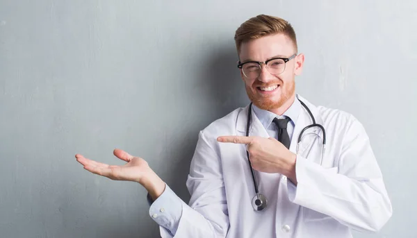 Young Redhead Doctor Man Grey Grunge Wall Very Happy Pointing — Stock Photo, Image