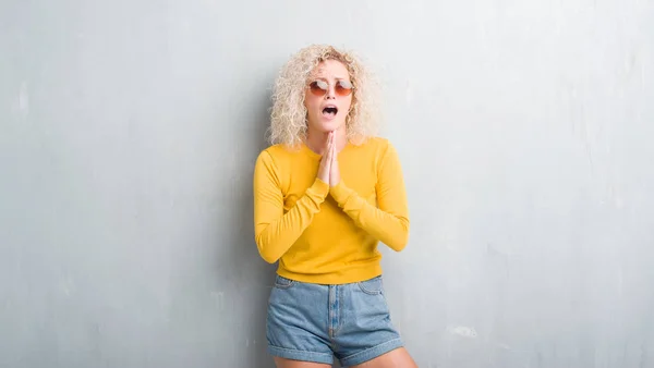 Jonge Blonde Vrouw Met Krullend Haar Grunge Grijze Achtergrond Bedelen — Stockfoto