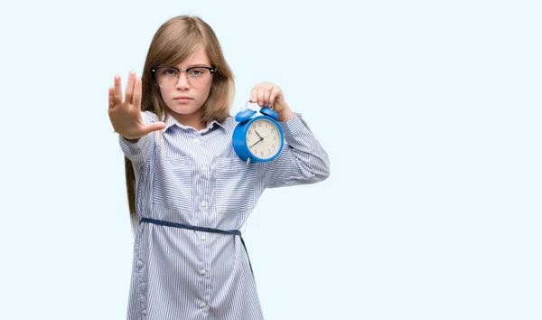 Young Blonde Child Holding Alarm Clock Open Hand Doing Stop — Stock Photo, Image