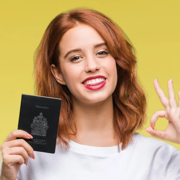 Joven Hermosa Mujer Sosteniendo Pasaporte Canadá Sobre Fondo Aislado Haciendo —  Fotos de Stock