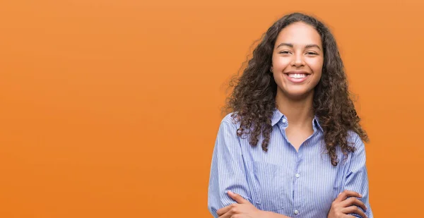 Young hispanic business woman happy face smiling with crossed arms looking at the camera. Positive person.