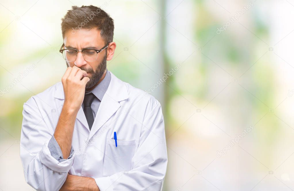 Adult hispanic scientist or doctor man wearing white coat over isolated background looking stressed and nervous with hands on mouth biting nails. Anxiety problem.