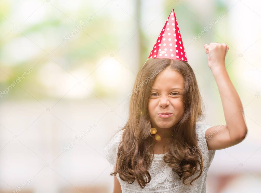Brunette hispanic girl wearing birthday hat annoyed and frustrated shouting with anger, crazy and yelling with raised hand, anger concept