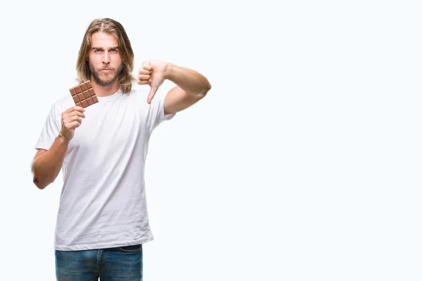 Young Handsome Man Long Hair Eating Chocolate Bar Isolated Background — Stock Photo, Image