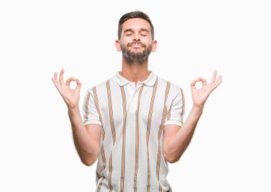 Yakışıklı delikanlı izole arka plan üzerinde dinlenmek ve gülümseyen gözlerle parmak ile meditasyon jest yapıyor kapalı. Yoga kavramı.