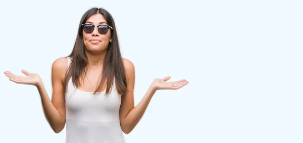 Young Beautiful Hispanic Wearing Sunglasses Clueless Confused Expression Arms Hands — Stock Photo, Image