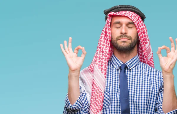 Young handsome arabian business man wearing keffiyeh over isolated background relax and smiling with eyes closed doing meditation gesture with fingers. Yoga concept.