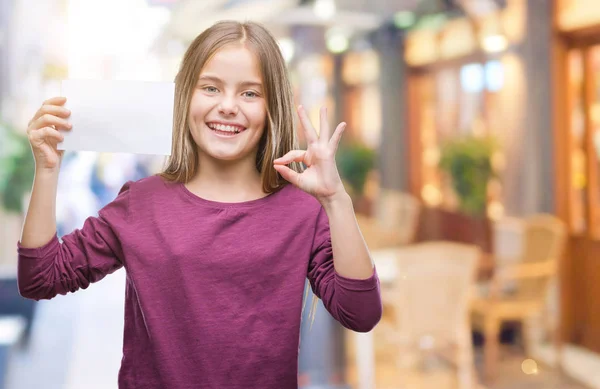 Menina Bonita Jovem Segurando Cartão Papel Branco Sobre Fundo Isolado — Fotografia de Stock