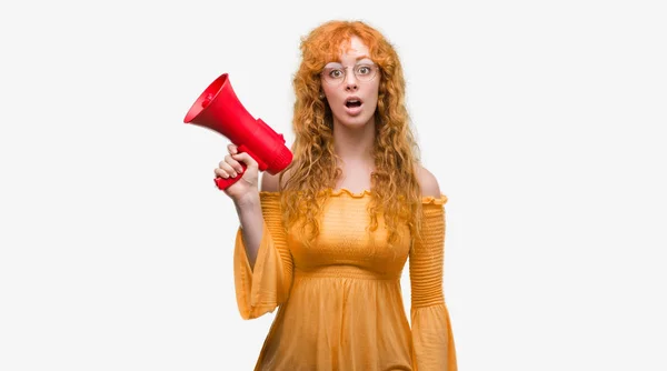 Young Redhead Woman Holding Megaphone Scared Shock Surprise Face Afraid — Stock Photo, Image