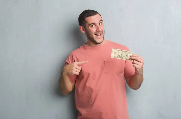 Joven Caucásico Hombre Sobre Gris Grunge Pared Mostrando Diez Dólares — Foto de Stock