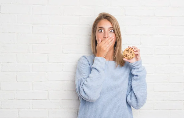 Piękna Młoda Kobieta Biały Cegła Mur Jedzenia Czekoladowe Cooky Pokrywa — Zdjęcie stockowe