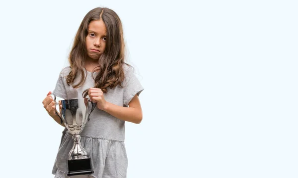 Brunette Hispanic Girl Holding Trophy Confident Expression Smart Face Thinking — Stock Photo, Image