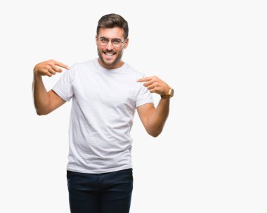 Yüzünde gülümseme ile kendinden emin görünüyorsun, kendini gururlu ve mutlu parmakları ile işaret izole arka plan üzerinde gözlük takan genç yakışıklı adam.