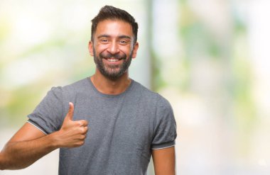 Hareketi el ile mutlu yaşasın yapıyor izole arka plan yetişkin İspanyol adam. Kameraya bakarak başarı gösteren ile ifade onaylama.