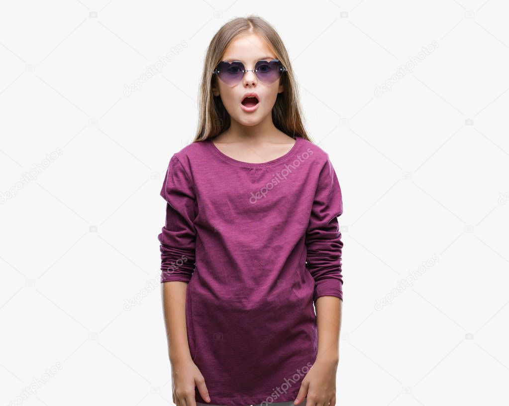 Young beautiful girl wearing sunglasses over isolated background afraid and shocked with surprise expression, fear and excited face.