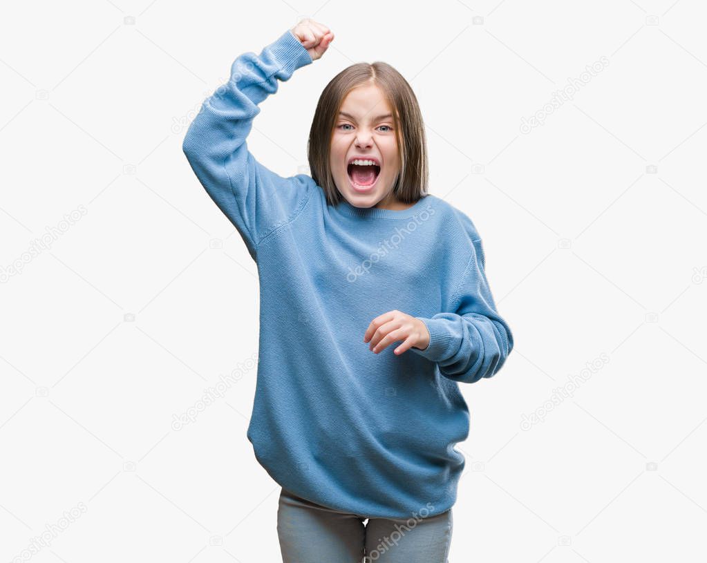 Young beautiful girl wearing winter sweater over isolated background angry and mad raising fist frustrated and furious while shouting with anger. Rage and aggressive concept.