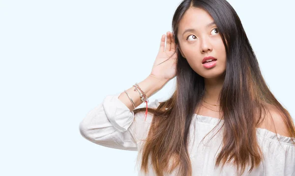 Jonge Aziatische Vrouw Geïsoleerde Achtergrond Glimlachend Met Hand Oor Luisteren — Stockfoto