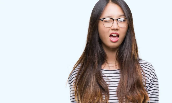 Joven Mujer Asiática Con Gafas Sobre Fondo Aislado Guiño Mirando —  Fotos de Stock