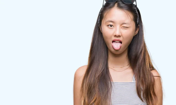 Young Asian Woman Wearing Sunglasses Isolated Background Sticking Tongue Out — Stock Photo, Image