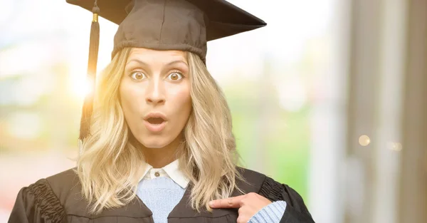 Young Graduate Woman Happy Surprised Cheering Expressing Wow Gesture Pointing — Stock Photo, Image