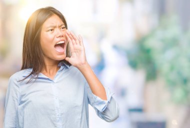 Genç Asyalı iş kadını bağırarak ve ağzı üzerinde el ile yan için çığlık izole arka plan üzerinde. İletişim kavramı.