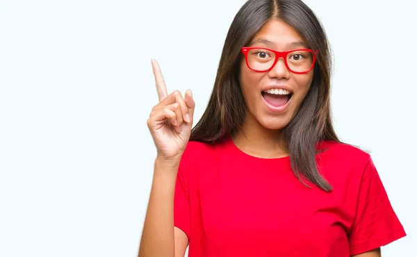 若いアジアの女性は 成功したアイデアを分離背景人差し指で眼鏡をかけてします 終了したと満足しています ナンバーワン — ストック写真