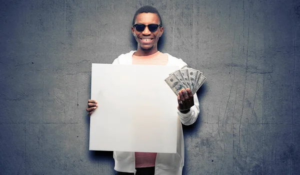 African man holding dollar bank notes holding blank advertising banner, good poster for ad, offer or announcement, big paper billboard
