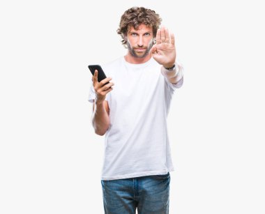 İspanyol yakışıklı modeli açık eliyle dur işareti ile ciddi ve kendine güvenen ifade, savunma jest yapıyor izole arka plan üzerinde Smartphone kullanarak mesaj mesaj gönderme