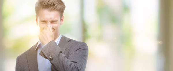 Young Handsome Blond Business Man Smelling Something Stinky Disgusting Intolerable — Stock Photo, Image