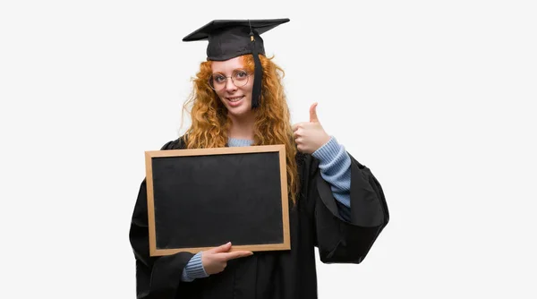 Young Redhead Student Woman Wearing Graduated Uniform Holding Blackboard Happy — Stock Photo, Image