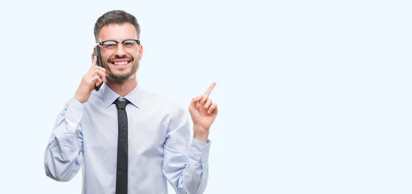 Young Business Adult Man Talking Phone Very Happy Pointing Hand — Stock Photo, Image