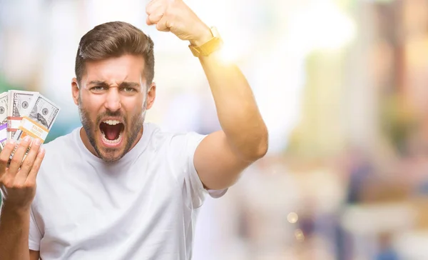 Joven Hombre Guapo Sosteniendo Pila Dólares Sobre Fondo Aislado Molesto — Foto de Stock