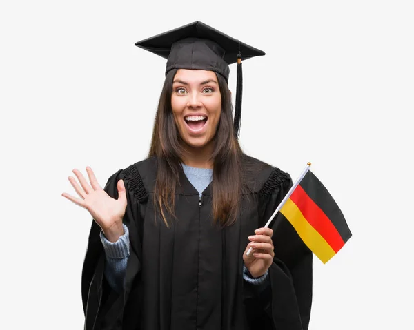 Mujer Hispana Joven Con Uniforme Graduado Sosteniendo Bandera Alemania Muy —  Fotos de Stock